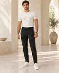 Black Copper Luxury Rox Jersey Track Pants by UNIKCOSA — front model styling view