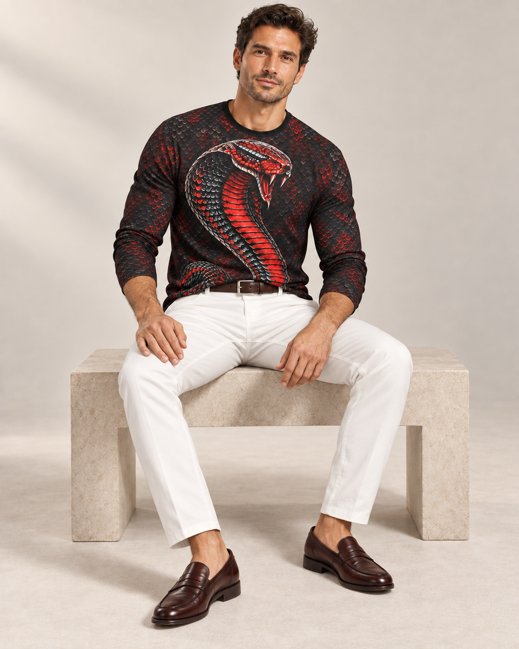 Cobra Elite Luxury Long Sleeve T-Shirt by UNIKCOSA, seated view with white tailored trousers and cherry-brown loafers — AI-generated model illustration