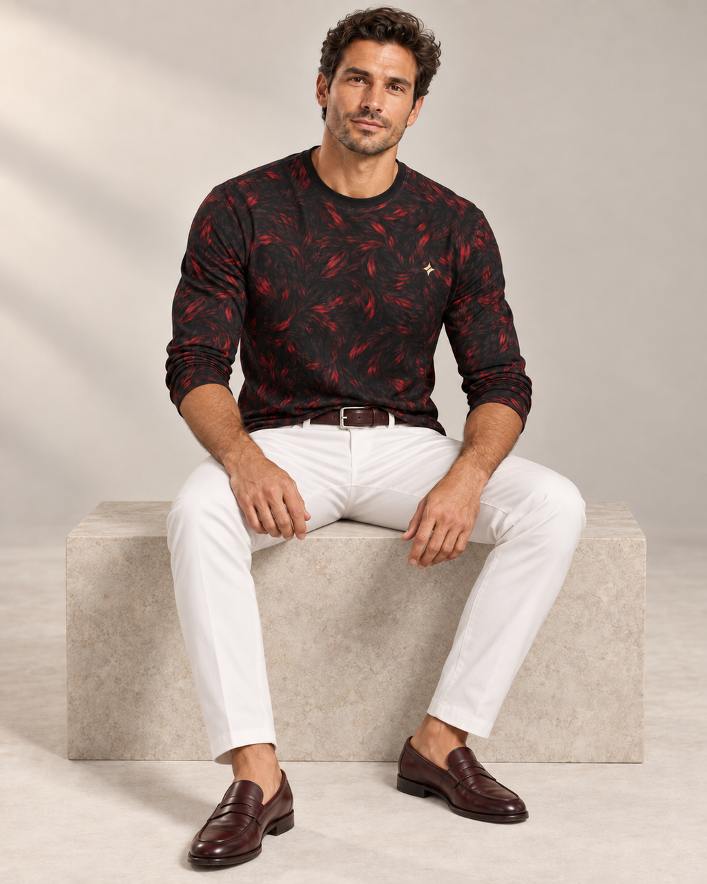 Crimson Frame Luxury Long Sleeve T-Shirt by UNIKCOSA, seated view with white tailored trousers and cherry-brown loafers — AI-generated model illustration