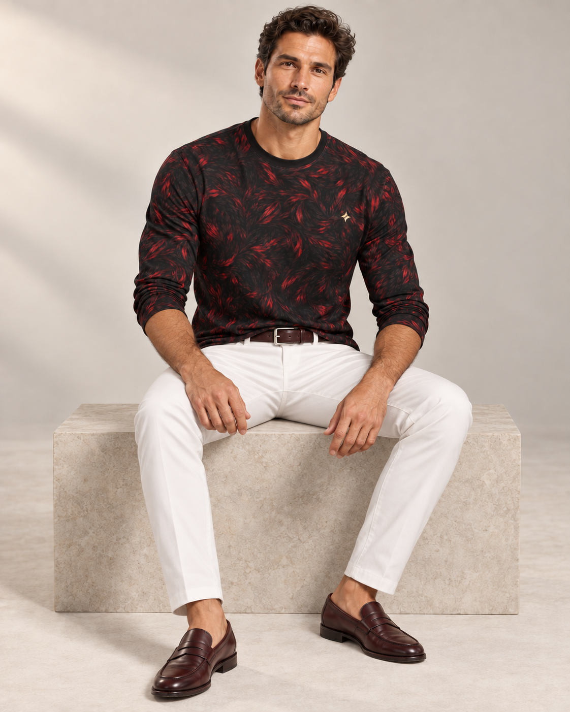 Crimson Frame Luxury Long Sleeve T-Shirt by UNIKCOSA, seated view with white tailored trousers and cherry-brown loafers — AI-generated model illustration