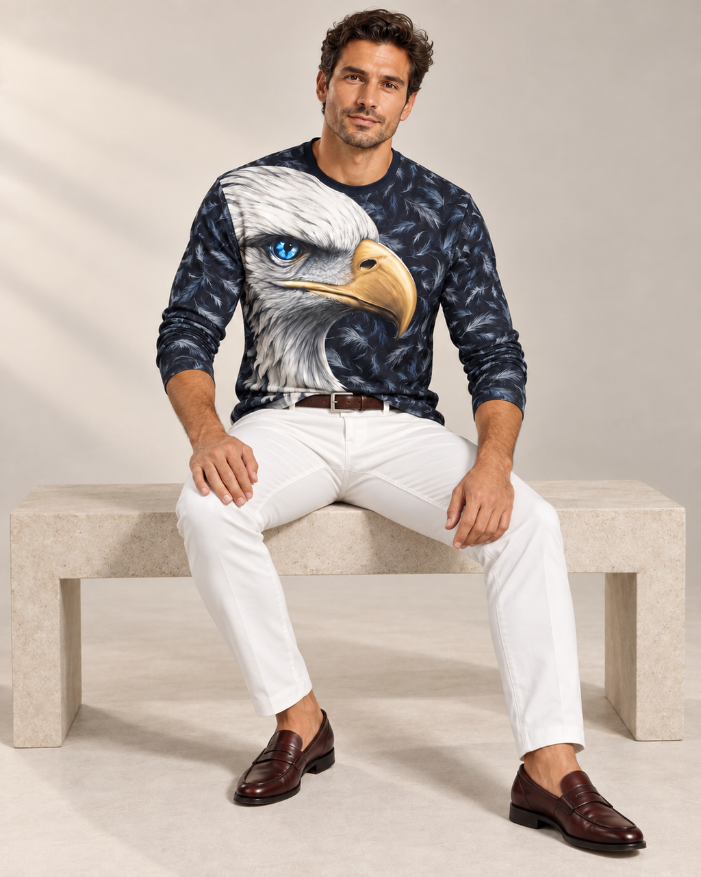 Frost Eagle Luxury Long Sleeve T-Shirt by UNIKCOSA, seated view with white tailored trousers and cherry-brown loafers — AI-generated model illustration