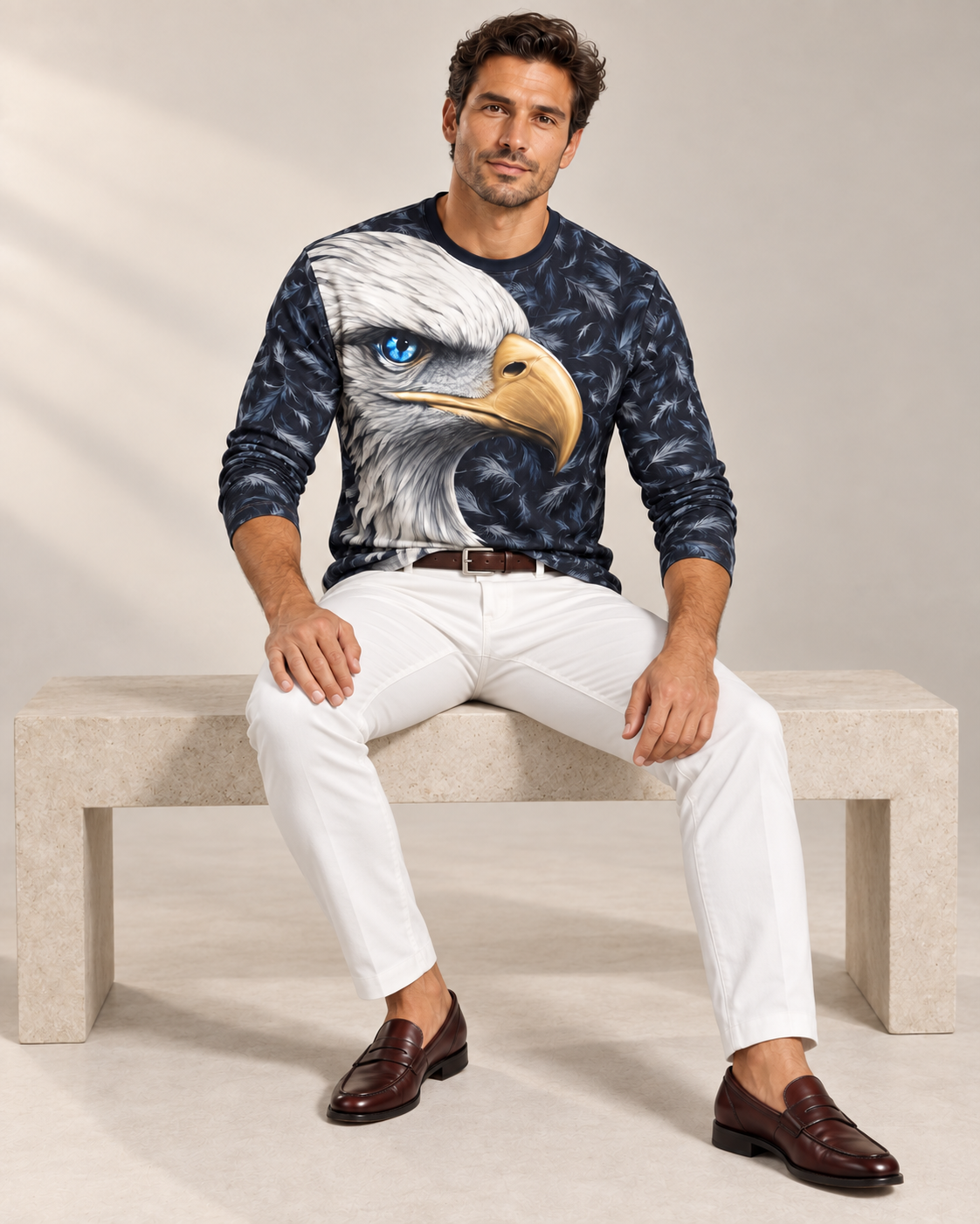 Frost Eagle Luxury Long Sleeve T-Shirt by UNIKCOSA, seated view with white tailored trousers and cherry-brown loafers — AI-generated model illustration