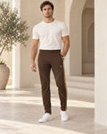 Mocha Caramel Luxury Rox Jersey Track Pants by UNIKCOSA — front model styling view