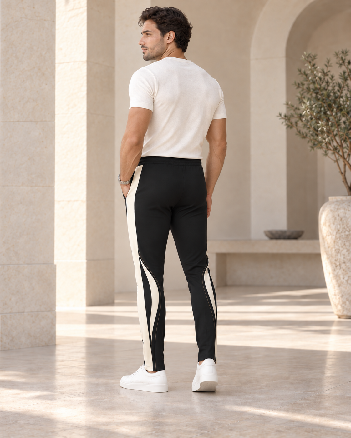 Onyx Ivory Luxury Rox Jersey Track Pants by UNIKCOSA — rear three-quarter model styling view