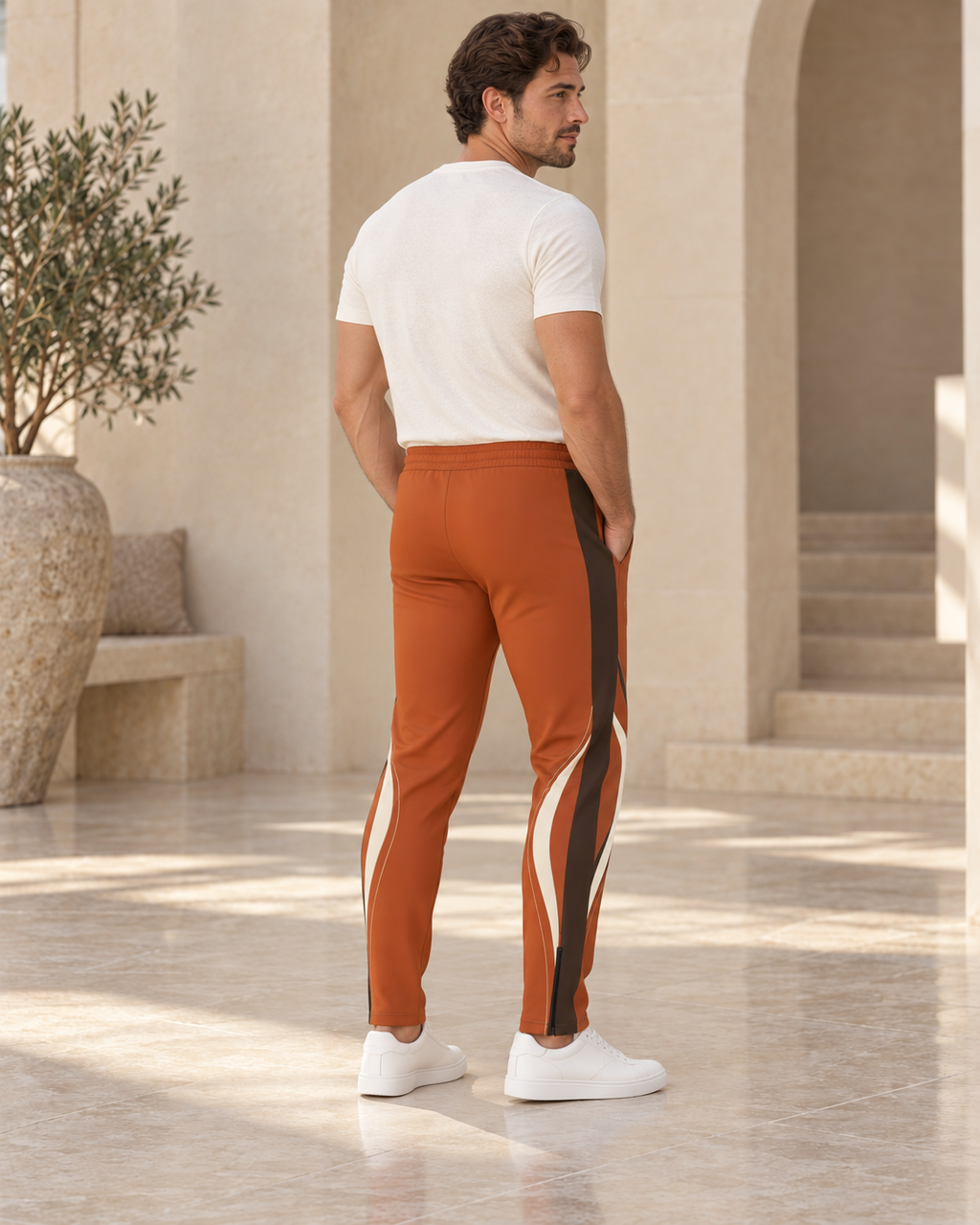 Rust Orange Luxury Rox Jersey Track Pants by UNIKCOSA — rear three-quarter model styling view