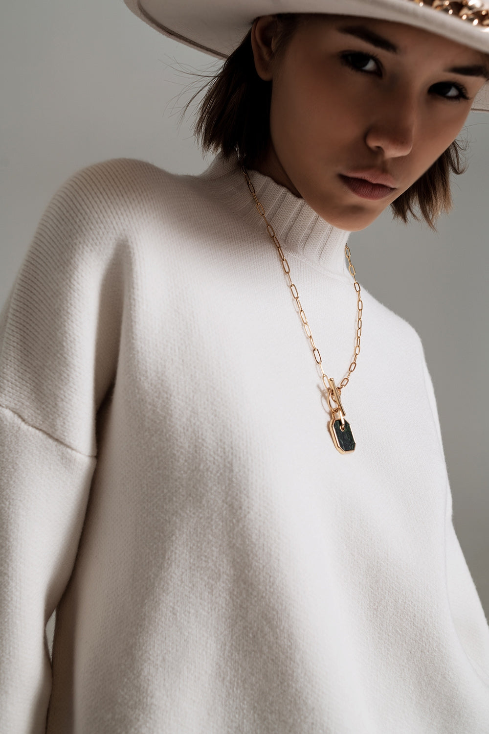 white jumper with black ribbed cuffs and hem